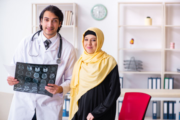 Fototapeta na wymiar Female arab patient visiting male doctor