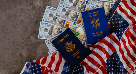 Fototapeta na wymiar Ukrainian passport and American Passport in the US flag with bills of one hundred dollars
