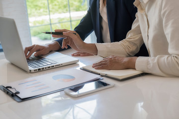 Business team brainstorming and discussing with financial data and report graph. Teamwork meeting working concept.