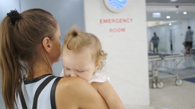 Mom And Child Come In In The Emergency Room At The Hospital In Pattaya Thailand.