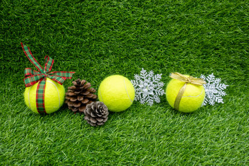 Merry Christmas to Tennis player with Christmas decoration on green grass background