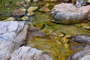 Fototapeta na wymiar stones and water, fragment of the mountain landscape macro