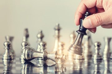 hand of businessman moving chess figure in competition success play. strategy, management or leadership