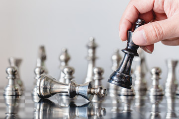 hand of businessman moving chess figure in competition success play. strategy, management or leadership