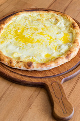 Traditional Turkish Pide at Kebab Restaurant on Wooden Table.
