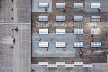 roof of an industrial building with skylights and ventilation. aerial top view