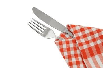 Knife and fork with red checked tablecloth isolated.