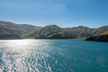 Beautifil rugged costal scenery sailing across the ocean in New Zealand