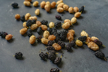 mulberry berries of white and black color macro shot