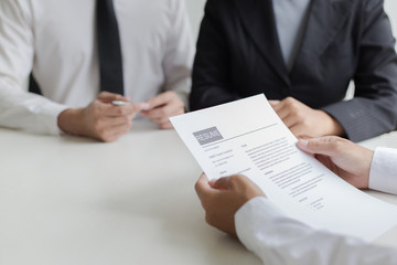 Executives are interviewing job applicants and preliminary background checks, candidates are talking about their past work experience, personal managers make hiring decisions.