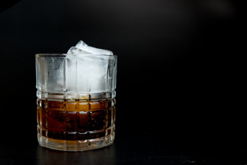 Refreshing black soda soft drinks with ice in a clear glass