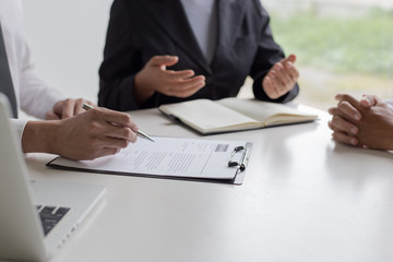 Executives are interviewing job applicants and preliminary background checks, candidates are talking about their past work experience, personal managers make hiring decisions.