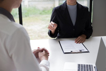 Executives are interviewing job applicants and preliminary background checks, candidates are talking about their past work experience, personal managers make hiring decisions.