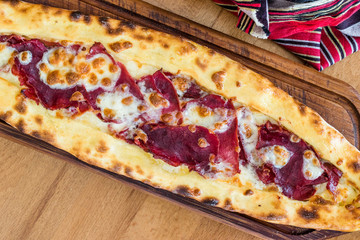 Traditional Turkish Pide at Kebab Restaurant on Wooden Table.