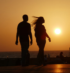 silhouette of a couple on the beach at sunset