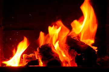 Wallpaper with a bright fire inside the brazier. Flame of fire. Preparation for cooking barbecue, kebabs. Hot coal with lights.