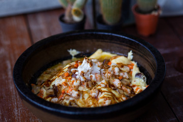 Creamy omelet with seafood on rice