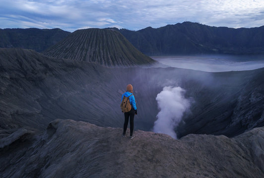 Woman standing on edge of crater  Bromo volcano, East Java, Indonesia