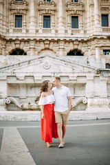 Fototapeta na wymiar Stylish loving couple walking and laughing. Wedding shooting on the streets of Rome, Italy.
