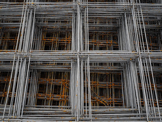 Fototapeta na wymiar Metal mesh for concrete reinforcement. Rusty bars of metal for use in construction