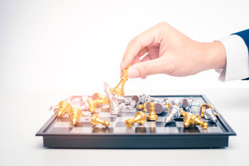 Close up of Business man is playing chess, business management strategy concept