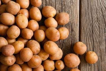 petite potatoes on rustic wood table background