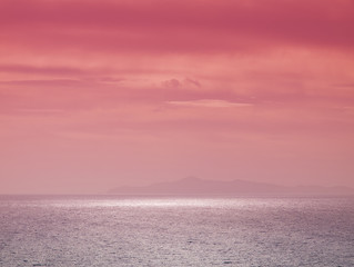 Beautiful  sunset above sea  in Attica, Greece. Sunlight reflecting on water.