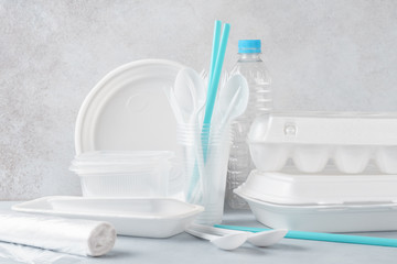 Set of white plastic disposable tableware and packaging.