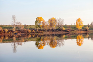 Idyllic autumn scenery with nature reflection in the water 