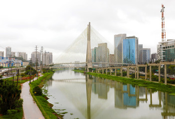 Fototapeta na wymiar Sao Paulo city landmark Estaiada Bridge reflex in Pinheiros river, Sao Paulo, Brazil