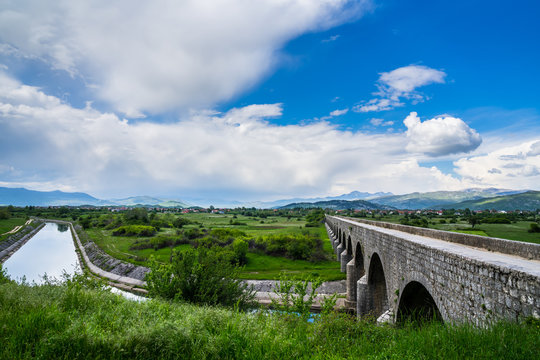 Montenegro, Ancient bridge emperors bridge building over zeta river water in niksic town surrounded by mountains in green nature landscape