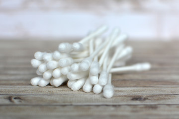 Fototapeta na wymiar Bunch of white cotton swabs without plastic on wooden background