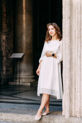 Naklejka premium Wedding photo shoot of the bride in Italy. Portrait of a stylish girl on the streets of Rome.