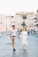 Fototapeta premium Beautiful stylish pair of in the European style. Wedding photo shoot on the streets of Rome.