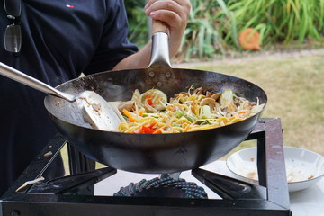 Cooking asian food in a wok pan