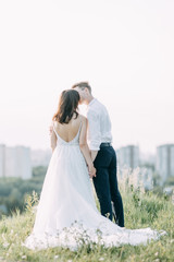 Happy couple outdoors at sunset. A stylish wedding in the European style of fine art.