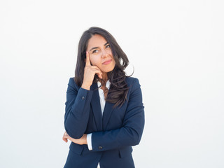 Satisfied pensive business woman thinking over pleasant issues. Young Latin office worker leaning...