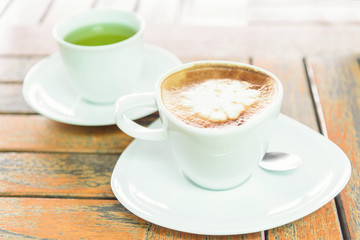 hot coffee on table / hot cappuccino with nice pattern milk foam 