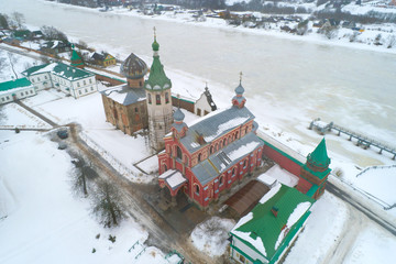 Over the ancient temples of the Old Ladoga Nikolsky Monastery on an overcast February day (filming from a quadcopter). Staraya Ladoga, Russia