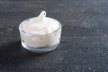 moisturizer on old black wood table