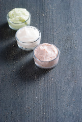 moisturizers on old black wood table