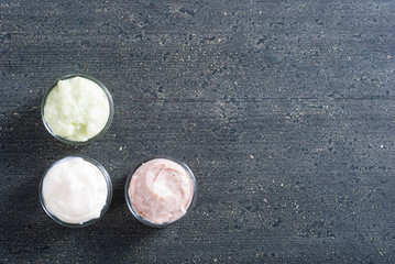 moisturizers on old black wood table