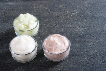 moisturizers on old black wood table