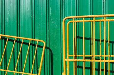 green color metal wall and yellow barrier background