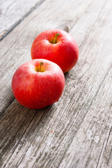 two apples on old wood table