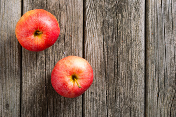 two apples on old wood table