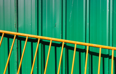 green color metal wall and yellow barrier background