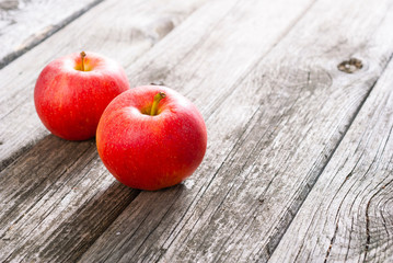 two apples on old wood table