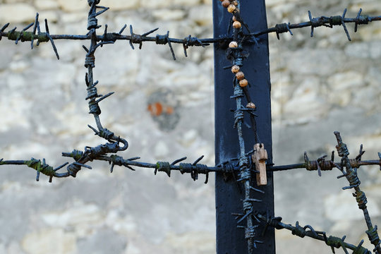 rosary hanging off a monument commemorating victims of German nazis from world war 2 in Kazimierz Dolny, Poland