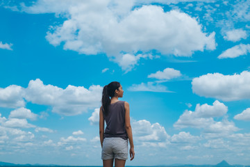 lifestyle concept - beautiful happy woman enjoying summer outdoors over blue sky.